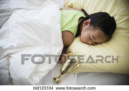 Korean girl sleeping with trophy View Large Photo Image Picture - Korean girl sleeping with trophy. Fotosearch
