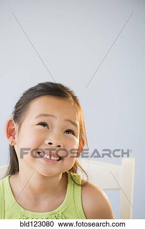 Korean girl smiling and looking up View Large Photo Image Stock Image - Korean girl smiling and looking up. Fotosearch