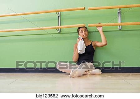 Mixed race ballerina sitting below barre View Large Photo Image Stock Image - Mixed race ballerina sitting below barre. Fotosearch
