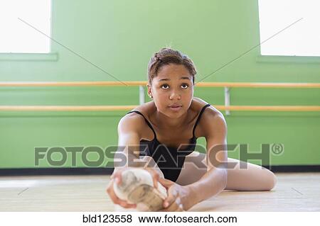 Mixed race ballerina stretching in studio View Large Photo Image Stock Photo - Mixed race ballerina stretching in studio. Fotosearch
