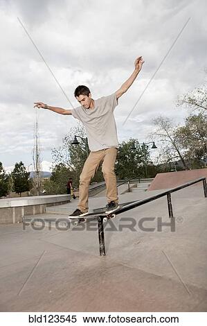 Mixed race boy skateboarding in park View Large Photo Image Stock Photography - Mixed race boy skateboarding in park. Fotosearch