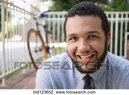 Mixed race businessman smiling outdoors View Large Photo Image Stock Image - Mixed race businessman smiling outdoors. Fotosearch