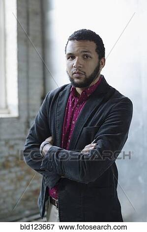 Mixed race businessman standing in warehouse View Large Photo Image Stock Photo - Mixed race businessman standing in warehouse. Fotosearch