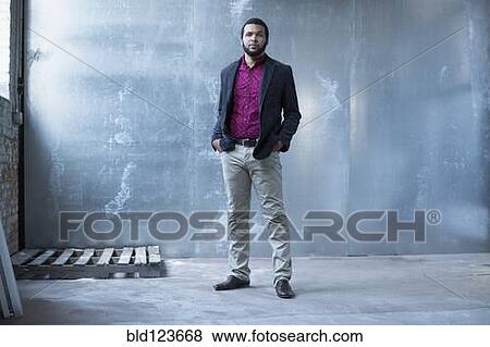 Mixed race businessman standing in warehouse View Large Photo Image Stock Photo - Mixed race businessman standing in warehouse. Fotosearch
