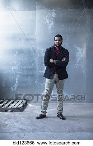 Mixed race businessman standing in warehouse View Large Photo Image Stock Photograph - Mixed race businessman standing in warehouse. Fotosearch