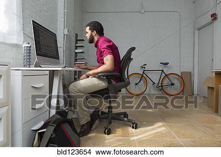 Mixed race businessman working at desk View Large Photo Image Picture - Mixed race businessman working at desk. Fotosearch