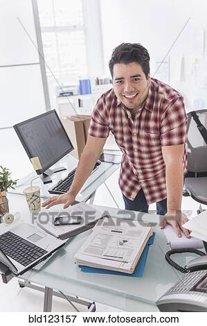 Mixed race businessman working at desk View Large Photo Image Stock Photo - Mixed race businessman working at desk. Fotosearch