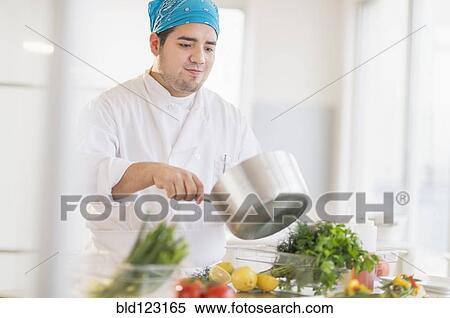 Mixed race chef cooking in restaurant View Large Photo Image Stock Photography - Mixed race chef cooking in restaurant. Fotosearch