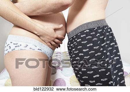 Mixed race couple hugging woman's pregnant belly View Large Photo Image Stock Image - Mixed race couple hugging woman's pregnant belly. Fotosearch