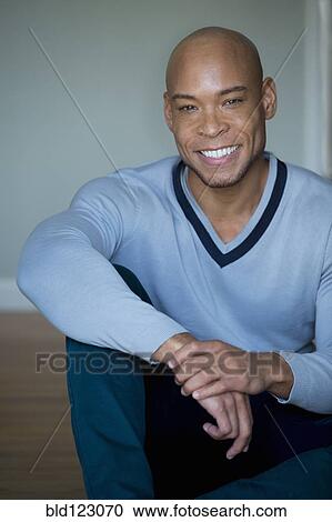 Mixed race man in v-neck sweater View Large Photo Image Stock Image - Mixed race man in v-neck sweater. Fotosearch