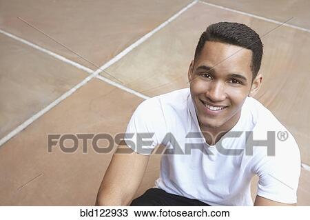 Stock Image - Mixed race man smiling outdoors. Fotosearch