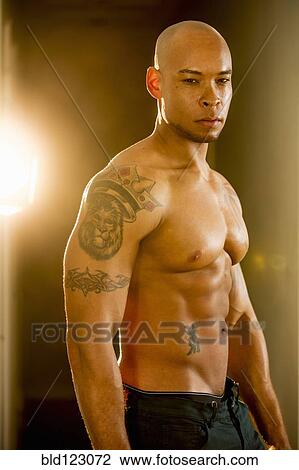 Mixed race man with tattoos on arm View Large Photo Image Stock Image - Mixed race man with tattoos on arm. Fotosearch