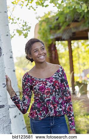Mixed race teenage girl smiling outdoors View Large Photo Image Stock Image - Mixed race teenage girl smiling outdoors. Fotosearch