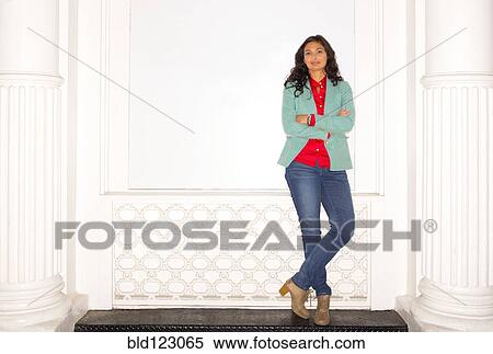 Stock Photography - Mixed race woman standing on bench. Fotosearch