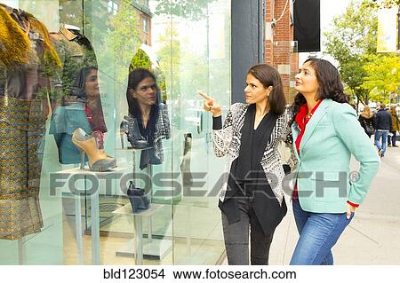 Picture - Mixed race women window shopping. Fotosearch
