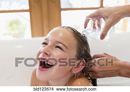 Mother washing daughter's hair View Large Photo Image Picture - Mother washing daughter's hair. Fotosearch