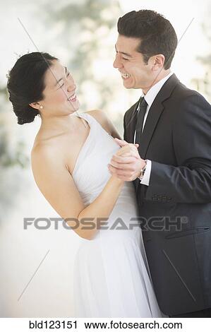 Newlywed couple dancing at wedding reception View Large Photo Image Stock Image - Newlywed couple dancing at wedding reception. Fotosearch