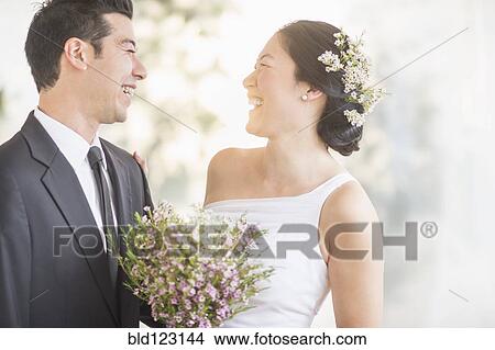 Picture - Newlywed couple laughing. Fotosearch