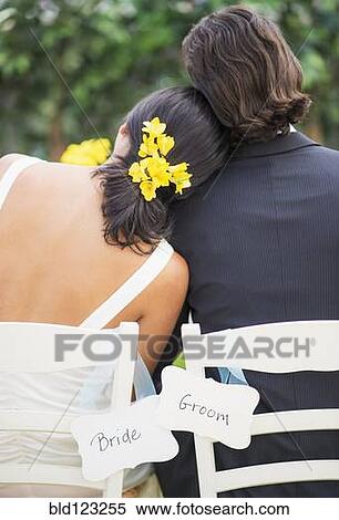 Newlywed couple sitting at wedding reception outdoors View Large Photo Image Stock Photography - Newlywed couple sitting at wedding reception outdoors. Fotosearch