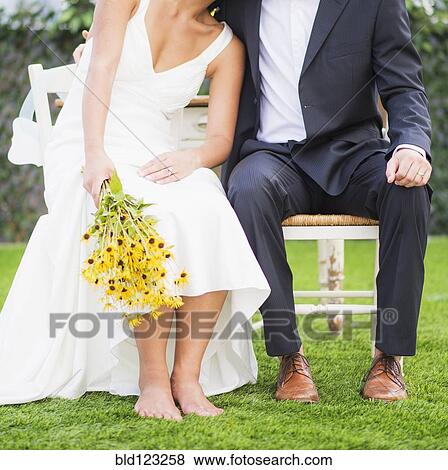 Newlywed couple sitting outdoors View Large Photo Image Stock Photo - Newlywed couple sitting outdoors. Fotosearch