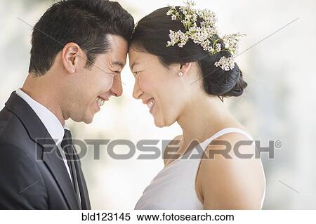Newlywed couple smiling face to face View Large Photo Image Stock Photography - Newlywed couple smiling face to face. Fotosearch
