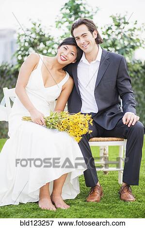 Newlywed couple smiling outdoors View Large Photo Image Stock Photo - Newlywed couple smiling outdoors. Fotosearch