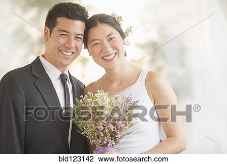 Stock Image - Newlywed couple smiling. Fotosearch
