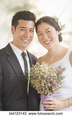 Stock Image - Newlywed couple smiling. Fotosearch