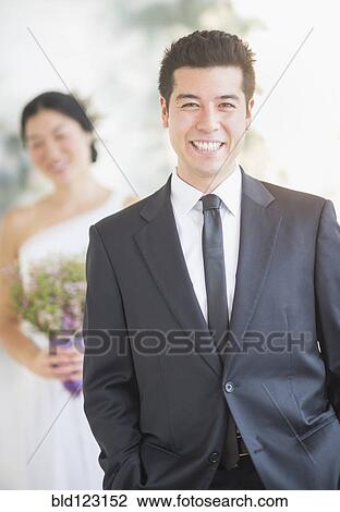 Stock Image - Newlywed groom smiling at wedding. Fotosearch