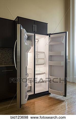Open empty refrigerator in modern kitchen View Large Photo Image Stock Photo - Open empty refrigerator in modern kitchen. Fotosearch