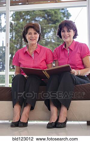 Senior Hispanic twins holding photograph album View Large Photo Image Stock Image - Senior Hispanic twins holding photograph album. Fotosearch