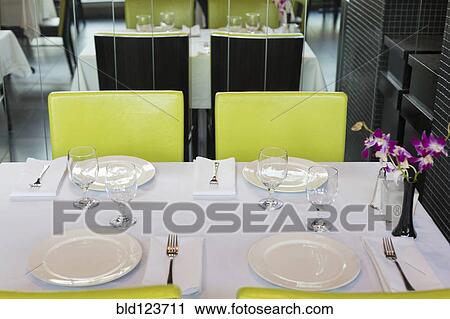 Stock Image - Set tables in Thai restaurant. Fotosearch