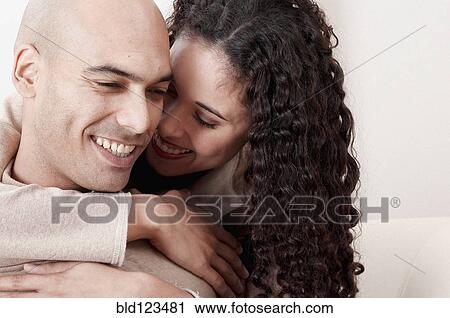 Stock Image - Smiling couple hugging. Fotosearch