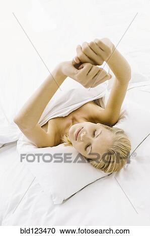 Smiling woman stretching in bed View Large Photo Image Stock Image - Smiling woman stretching in bed. Fotosearch