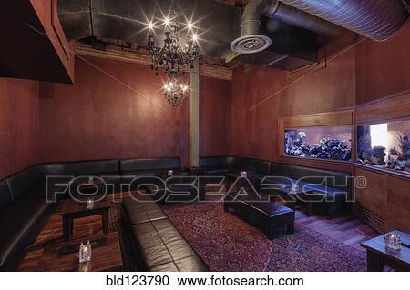 Stock Image - Tables and chairs in empty restaurant. Fotosearch