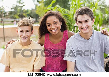 Teenagers smiling together outdoors View Large Photo Image Stock Image - Teenagers smiling together outdoors. Fotosearch