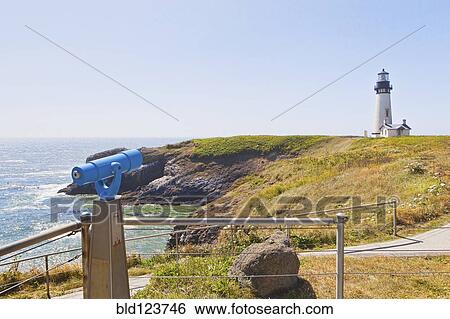 Stock Photograph - Telescope overlooking lighthouse on cliff, Newport, Oregon, United States. Fotosearch