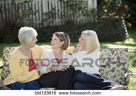 Three generations of Caucasian women relaxing outdoors View Large Photo Image Stock Photograph - Three generations of Caucasian women relaxing outdoors. Fotosearch
