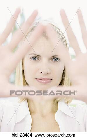 Woman framing her face with hands View Large Photo Image Picture - Woman framing her face with hands. Fotosearch