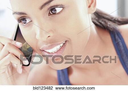 Stock Image - Woman talking on cell phone. Fotosearch