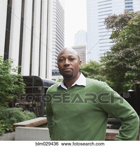 Stock Photograph - African American businessman smiling outdoors. Fotosearch