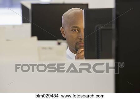 Picture - African American businessman working in office. Fotosearch