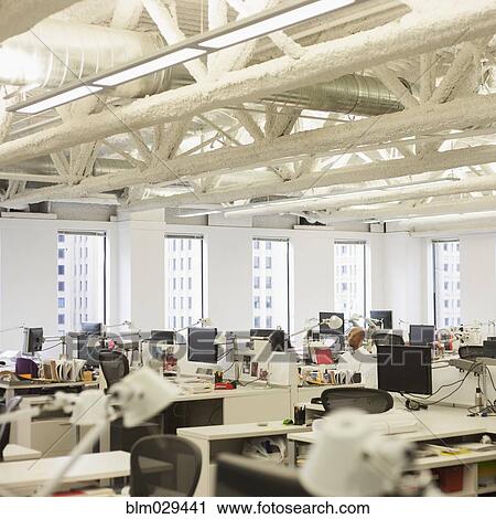 Stock Image - African American businessman working in empty office. Fotosearch