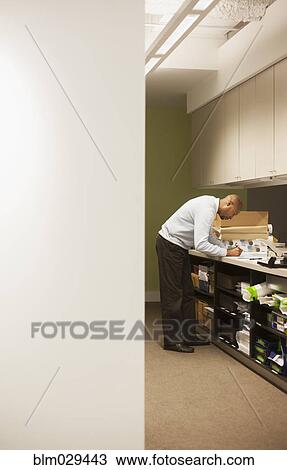 Stock Image - African American businessman working in office. Fotosearch
