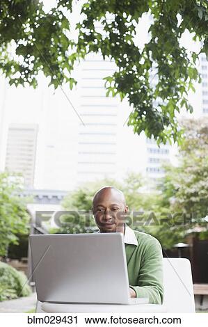 Stock Image - African American businessman working outdoors. Fotosearch