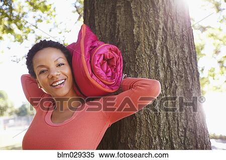 Black woman carrying yoga mat outdoors View Large Photo Image Stock Photography - Black woman carrying yoga mat outdoors. Fotosearch