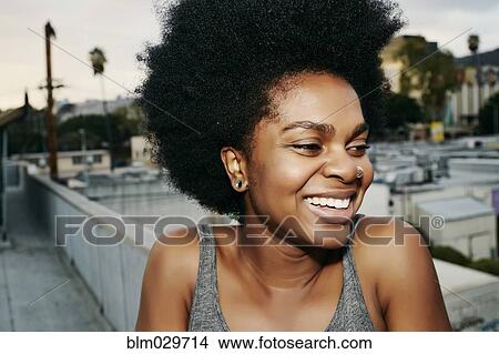 Black woman smiling on urban rooftop View Large Photo Image Picture - Black woman smiling on urban rooftop. Fotosearch