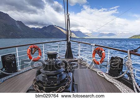 Boat on lake near mountains View Large Photo Image Picture - Boat on lake near mountains. Fotosearch