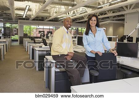 Business people smiling in office View Large Photo Image Stock Photo - Business people smiling in office. Fotosearch