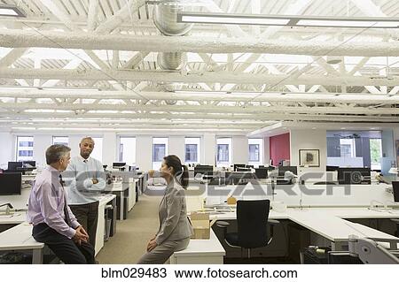 Stock Image - Business people talking in office. Fotosearch